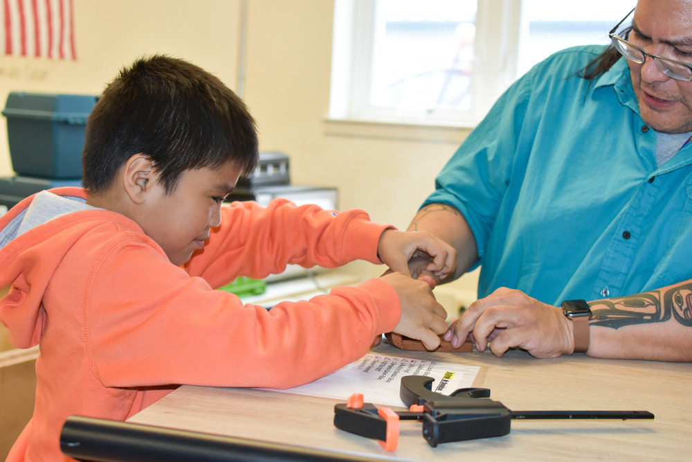 student and teacher working on a bentwood box in class