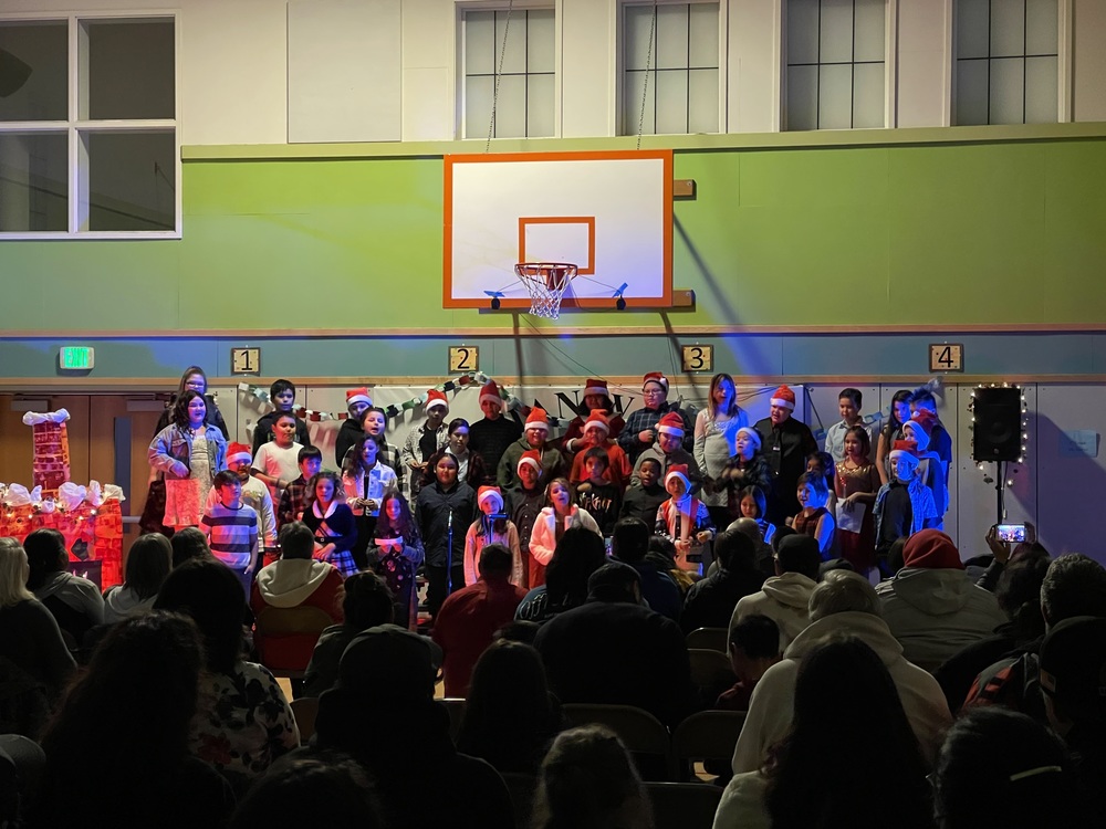 students in concert in gym with festive outfits on
