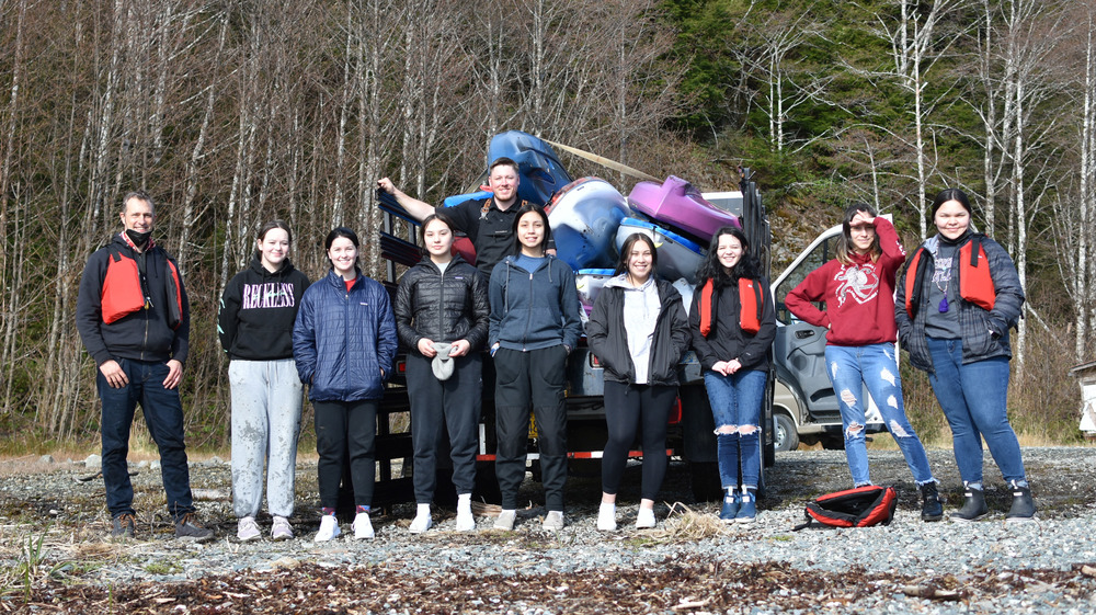 Students and Teachers standing in front of a truck filled with kayaks