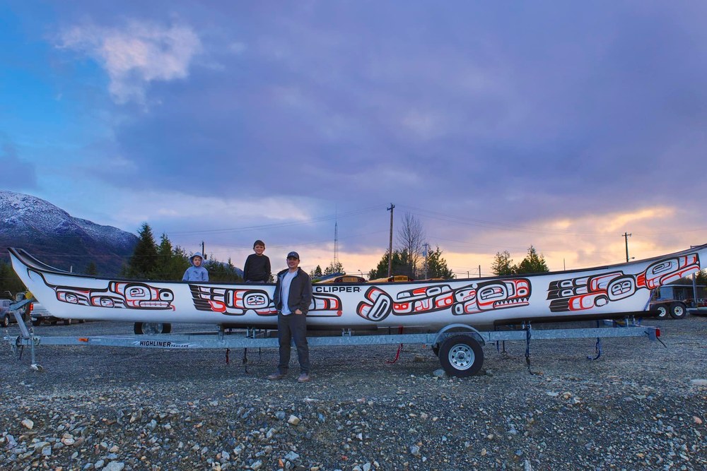 Clifton Guthrie and the 40' Canoe with Tsimshian art painted by AISD Students