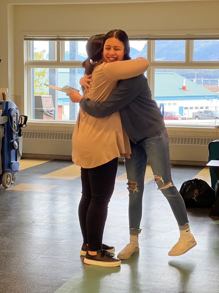 student giving teacher a hug