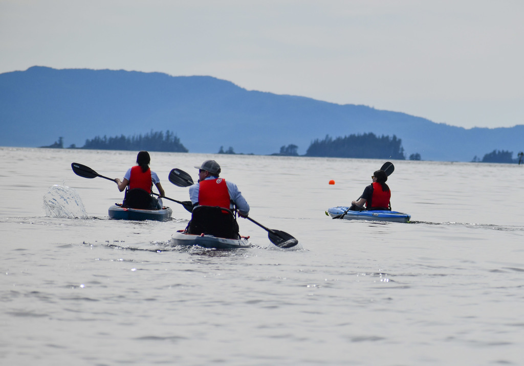 students and teacher kayaking