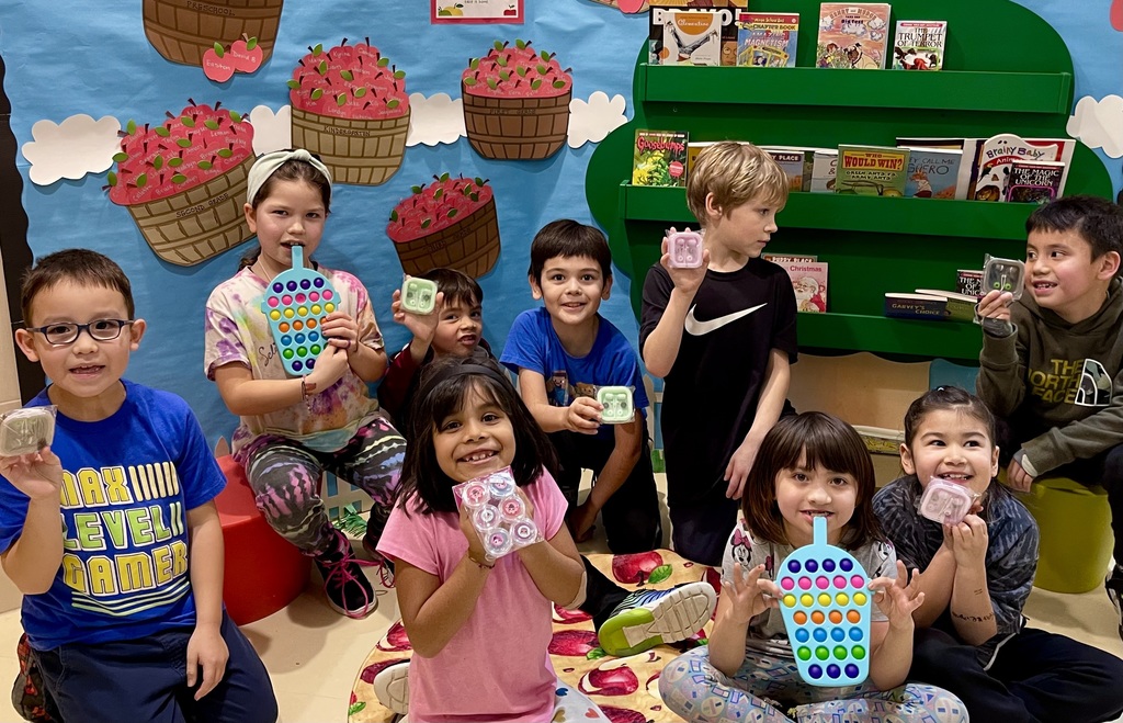 students smiling and holding prizes