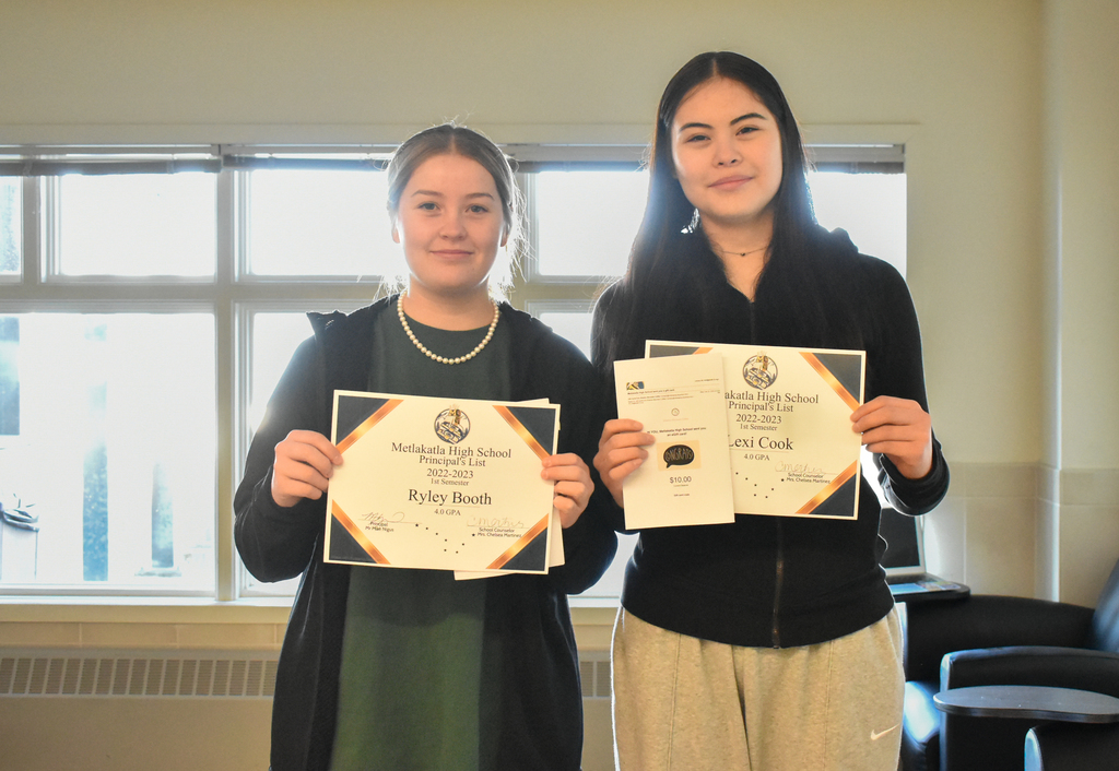 students holding up certificates