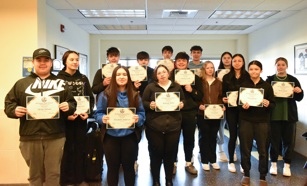 students holding up certificates