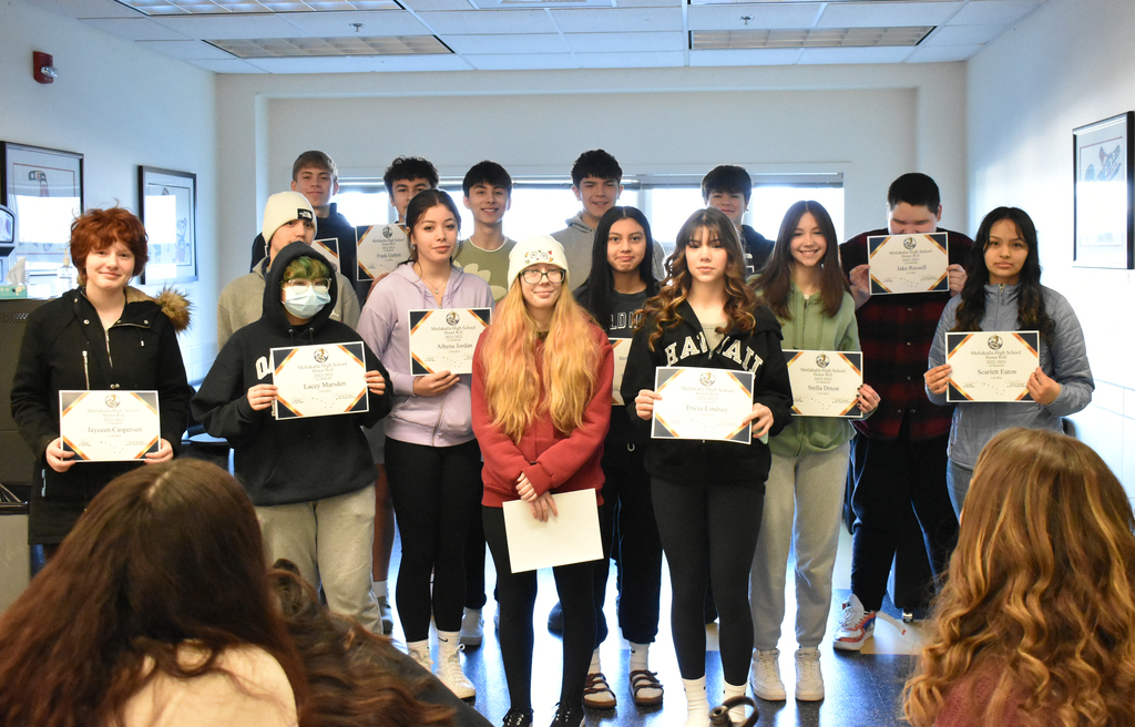 students holding up certificates