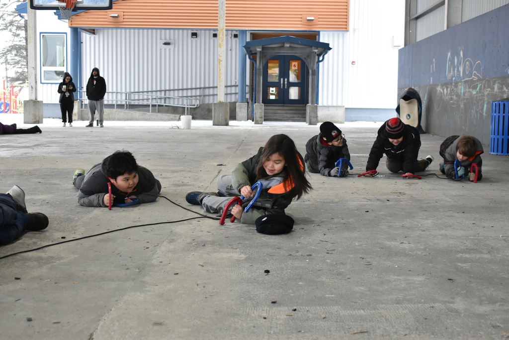 students crawling and laughing with ropes