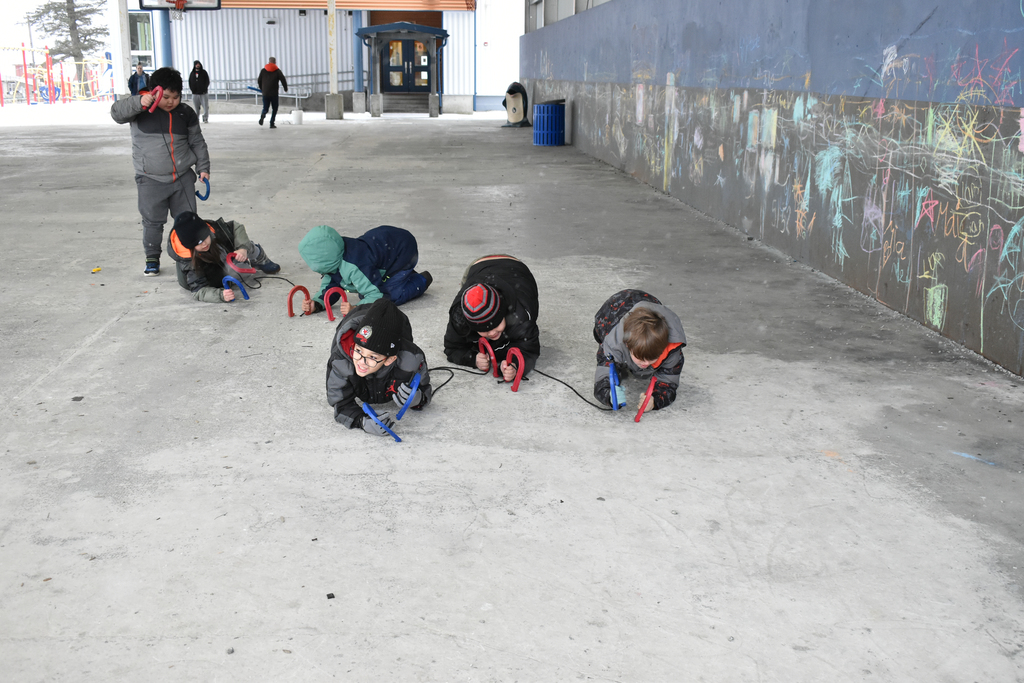 students crawling and laughing with ropes