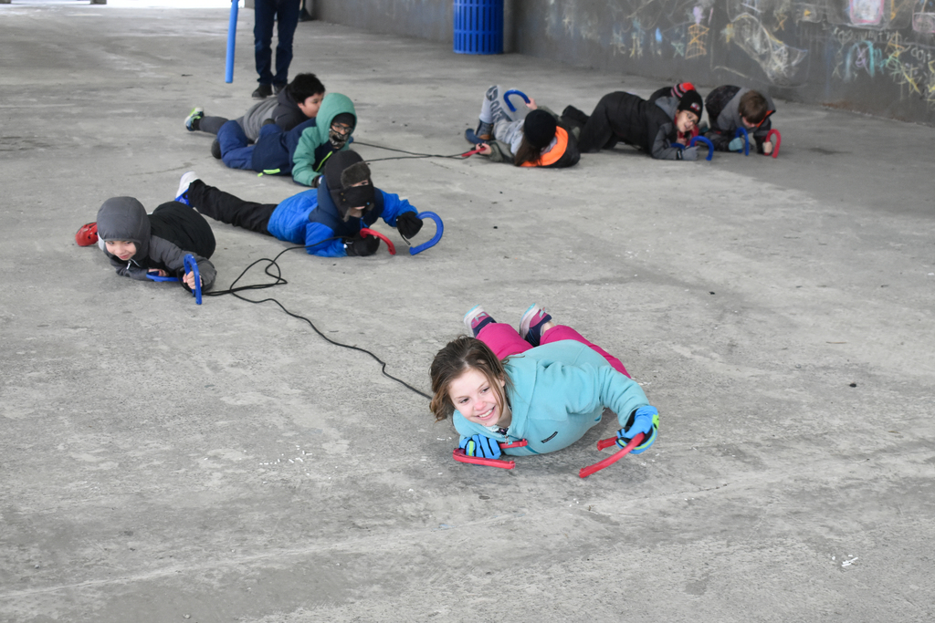 students crawling and laughing with ropes
