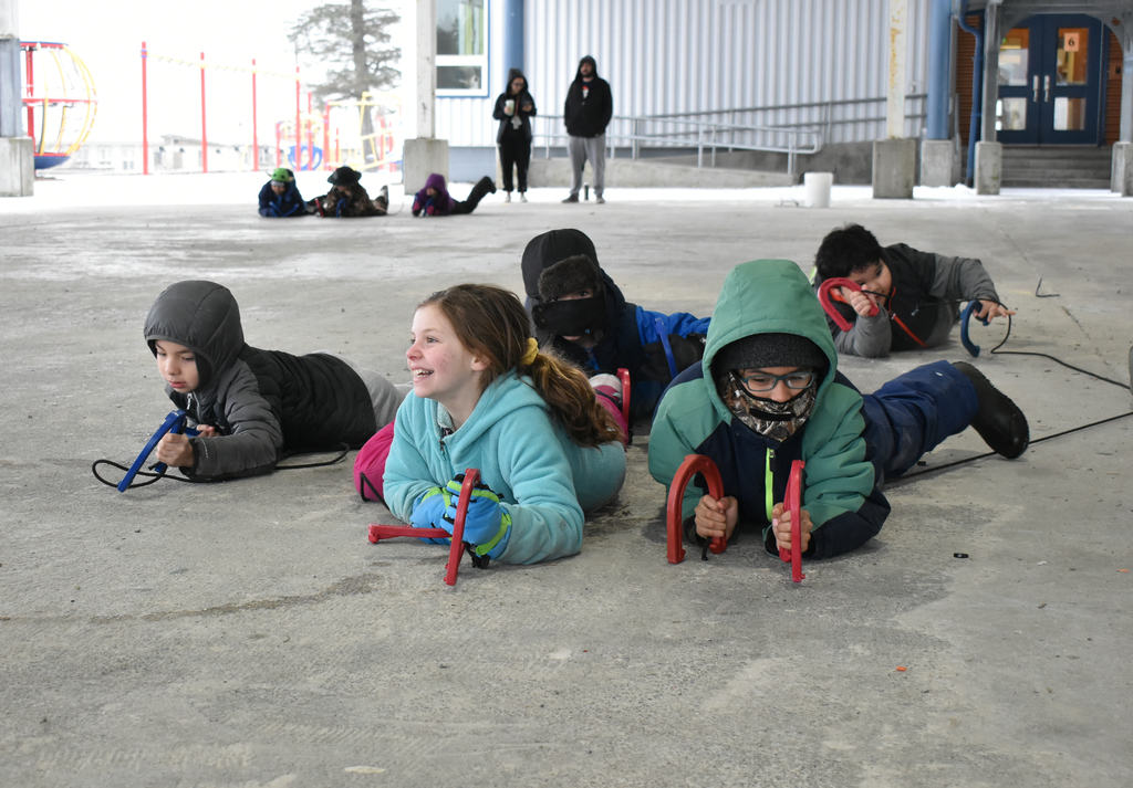 students crawling and laughing with ropes