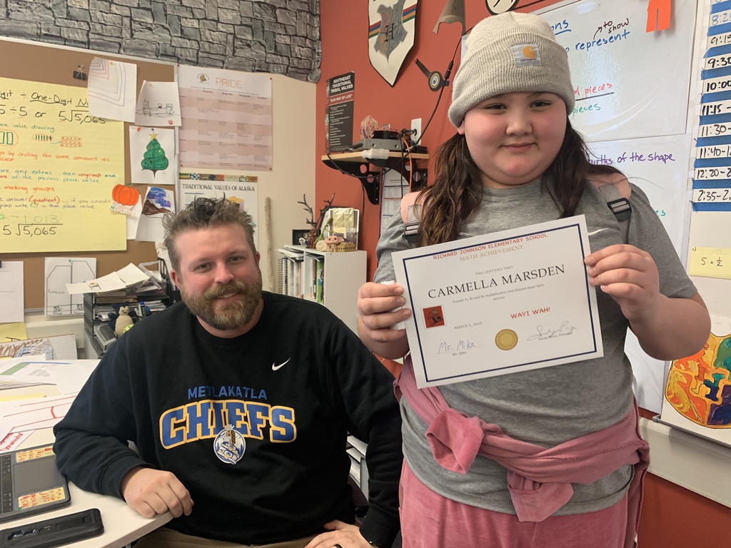 student holding certificate and smiling