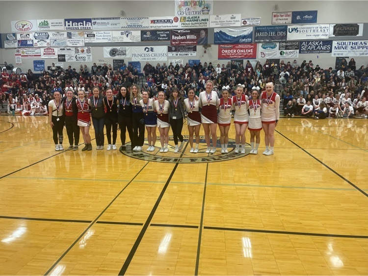 students holding certificates in a gym