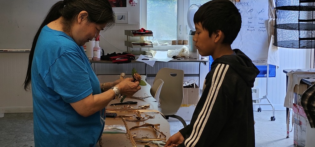 teacher and student working with bark