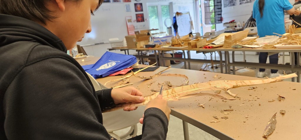 student working with bark