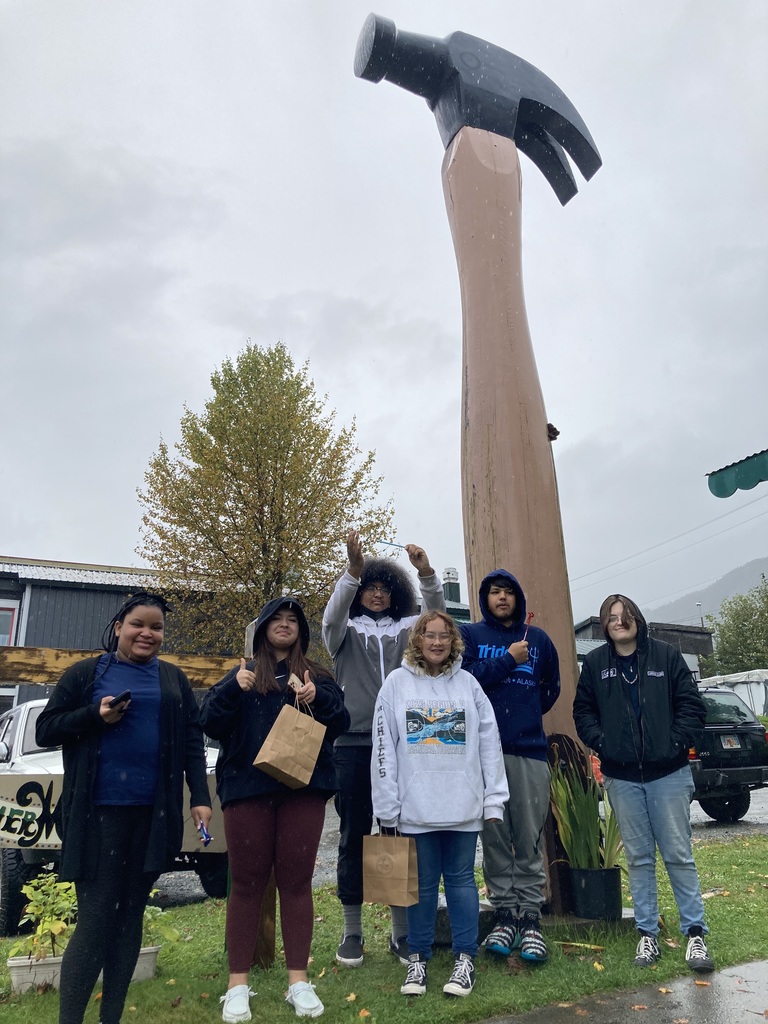 students next to hammer statue